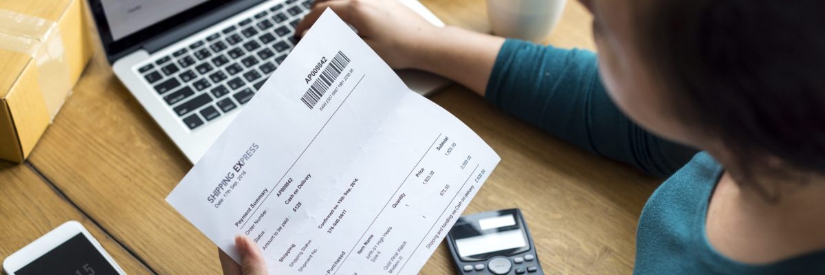 Woman checking shipping letter